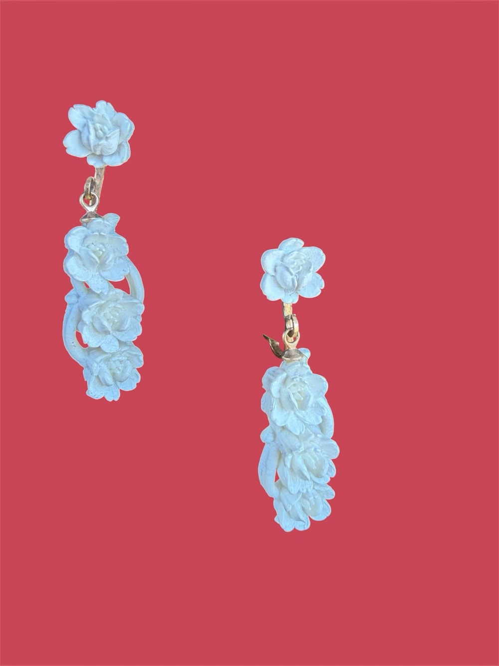 White carved clip earrings